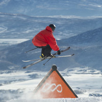 Skier doing a grab off a feature at Canyons at Park City Mountain
