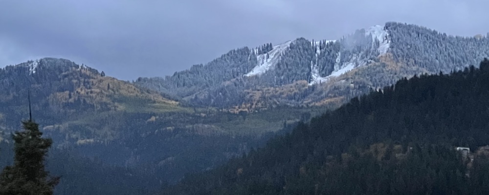 Condor mountain blanketed in snow with Aspen trees a fall yellow